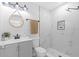 Bright bathroom features tiled walk-in shower, modern vanity with a marble countertop at 6370 Elmhurst Dr, Pinellas Park, FL 33782