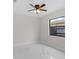 Bedroom with a ceiling fan, tiled floors, and a window offering ample natural light at 6370 Elmhurst Dr, Pinellas Park, FL 33782
