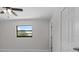 Bedroom with neutral walls, tile floors, a window, and a ceiling fan at 6370 Elmhurst Dr, Pinellas Park, FL 33782