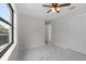 Bright bedroom featuring marble floors, a ceiling fan, and a large window at 6370 Elmhurst Dr, Pinellas Park, FL 33782