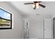 Spacious bedroom boasts a ceiling fan, tile floors, and bright natural light at 6370 Elmhurst Dr, Pinellas Park, FL 33782