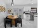 Bright eat-in kitchen with a unique light fixture, updated appliances, and lovely decor at 6370 Elmhurst Dr, Pinellas Park, FL 33782