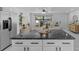 Modern kitchen featuring a granite island and is open to the living room at 6370 Elmhurst Dr, Pinellas Park, FL 33782