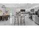 Modern kitchen with white cabinets, sleek appliances, granite countertops, and island seating at 6370 Elmhurst Dr, Pinellas Park, FL 33782