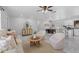 Open-concept living space with bright marble floors, modern furniture, and a dining area at 6370 Elmhurst Dr, Pinellas Park, FL 33782