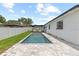 A beautiful in-ground pool is accompanied by seating and a white privacy fence at 6370 Elmhurst Dr, Pinellas Park, FL 33782