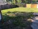 Spacious backyard featuring a combination of grass and foliage enclosed by wood fencing at 6403 Elliot Dr, Tampa, FL 33615