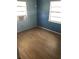A bedroom featuring dual windows and a fresh coat of blue paint at 6403 Elliot Dr, Tampa, FL 33615