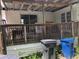 View of the back deck in disrepair with exposed ceiling at 6403 Elliot Dr, Tampa, FL 33615