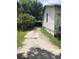 Exterior view of the driveway leading to detached garage at 6403 Elliot Dr, Tampa, FL 33615