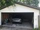 View of the detached garage with car and bicycle at 6403 Elliot Dr, Tampa, FL 33615
