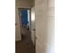 Hallway view into a room featuring neutral paint and wood look tile floors at 6403 Elliot Dr, Tampa, FL 33615