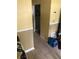 Hallway leads to a closet in a home featuring light yellow walls and ceramic tile floors at 6403 Elliot Dr, Tampa, FL 33615