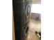 Modern laundry room with stacked washer and dryer at 6403 Elliot Dr, Tampa, FL 33615