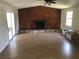 View of the spacious living room with hardwood floors and wood burning fireplace at 6403 Elliot Dr, Tampa, FL 33615