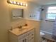 Clean bathroom features a vanity, a tub/shower, and tile flooring at 6925-A Avenue Des Palais # 1A, South Pasadena, FL 33707