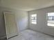 Bright bedroom features two windows offering natural light and a neutral color palette at 6925-A Avenue Des Palais # 1A, South Pasadena, FL 33707