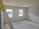 Bedroom with fresh paint, two windows, and flooring in need of replacement at 6925-A Avenue Des Palais # 1A, South Pasadena, FL 33707