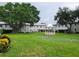 Lush green lawn with putting greens, mature trees, and a charming gazebo provide a tranquil setting at 6925-A Avenue Des Palais # 1A, South Pasadena, FL 33707