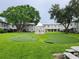 Lush green lawn with putting greens, mature trees, and a charming gazebo provide a tranquil setting at 6925-A Avenue Des Palais # 1A, South Pasadena, FL 33707