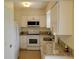 Charming kitchen features white appliances, granite counters, and ample cabinet space at 6925-A Avenue Des Palais # 1A, South Pasadena, FL 33707