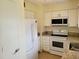 Well-equipped kitchen featuring white appliances, granite counters, and modern finishes at 6925-A Avenue Des Palais # 1A, South Pasadena, FL 33707