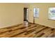 Bright and spacious living room featuring wood-look floors and natural light at 6925-A Avenue Des Palais # 1A, South Pasadena, FL 33707