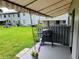 Relaxing patio area with awning, BBQ, and view of courtyard at 6925-A Avenue Des Palais # 1A, South Pasadena, FL 33707