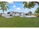 Lush backyard with green grass, fence, and in-ground pool at 7107 Limestone Ln, Tampa, FL 33619