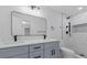 Modern bathroom features double sink vanity, new fixtures, and marble tiled shower at 7107 Limestone Ln, Tampa, FL 33619