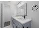 Updated bathroom featuring a double sink vanity with modern fixtures and new lighting at 7107 Limestone Ln, Tampa, FL 33619