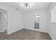 Bedroom with wood-look floors, and attached bathroom with new vanity at 7107 Limestone Ln, Tampa, FL 33619