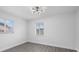 Bedroom with wood-look floors, and windows, and new light fixture at 7107 Limestone Ln, Tampa, FL 33619