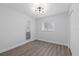 Bright bedroom features wood-look floors, neutral walls, and updated lighting fixture at 7107 Limestone Ln, Tampa, FL 33619