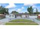 Landscaped front yard and driveway leading up to a charming, single-story home at 7107 Limestone Ln, Tampa, FL 33619