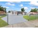 This single-story home is surrounded by a chain link fence and lush green grass at 7107 Limestone Ln, Tampa, FL 33619