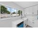 This newly renovated kitchen has quartz countertops, stainless appliances, and views of the pool at 7107 Limestone Ln, Tampa, FL 33619