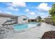 Backyard pool featuring a dolphin statue and exterior view of the house at 7107 Limestone Ln, Tampa, FL 33619