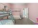 Pink bedroom featuring a bunk bed, wood-style floor, and a window at 7114 Bowspirit Pl, Apollo Beach, FL 33572