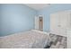 Blue bedroom with a double bed, wood-style floor, a window and a closet at 7114 Bowspirit Pl, Apollo Beach, FL 33572