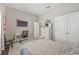Cozy bedroom featuring a desk, TV, closet, and neutral walls at 7114 Bowspirit Pl, Apollo Beach, FL 33572