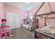 Pink bedroom with a bunk bed, wood-style floor, and a window at 7114 Bowspirit Pl, Apollo Beach, FL 33572