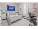 Well-lit bedroom with white furniture, complementing light walls and window with elegant, light-filtering curtains at 7114 Bowspirit Pl, Apollo Beach, FL 33572
