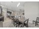 Open-concept dining area with a dark wood table and view into the spacious kitchen and living room at 7114 Bowspirit Pl, Apollo Beach, FL 33572