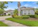 Attractive house featuring lush landscaping, mature trees, and a well-manicured lawn at 7114 Bowspirit Pl, Apollo Beach, FL 33572
