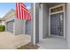Close up shot of the front door and three car garage at 7114 Bowspirit Pl, Apollo Beach, FL 33572