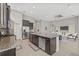 Open-concept kitchen with an island, granite countertops, and modern appliances with access to living area at 7114 Bowspirit Pl, Apollo Beach, FL 33572