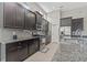 Modern kitchen featuring stainless steel appliances, dark cabinetry, and sleek countertops at 7114 Bowspirit Pl, Apollo Beach, FL 33572
