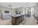 Open kitchen layout with island seating, stainless steel appliances, and access to dining and living areas at 7114 Bowspirit Pl, Apollo Beach, FL 33572