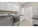 Laundry room featuring washer, dryer, white cabinets and a countertop at 7114 Bowspirit Pl, Apollo Beach, FL 33572